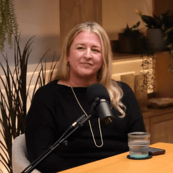 Person speaking in a cozy setting.