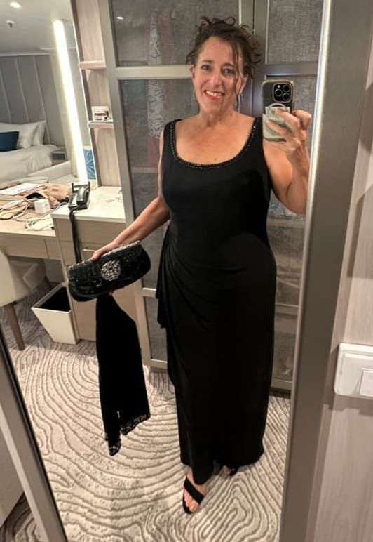 Personal styling client Nancy Lucas wearing a beaded black gown with embellished clutch and heeled sandals — styled by The Psychic Stylist™