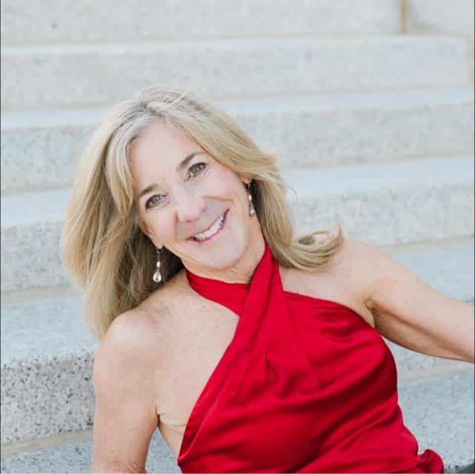 Woman in red dress on stairs.